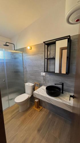a bathroom with a sink and a toilet and a shower at Casa de huéspedes Arroyo Bujías - 3 habitaciones con baño privado individual in Alora