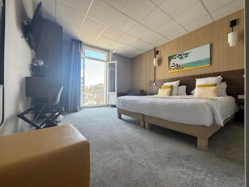 a bedroom with a large bed and a large window at Best Western Le Duguesclin Hôtel-Restaurant in Saint-Brieuc