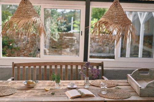 a wooden table with plates and books on it at Quinta Bohemia in Moncarapacho