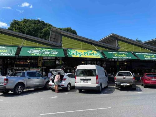 a parking lot with cars parked in front of a store at Apartment on Grafton in Cairns