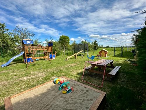 a park with a playground with a slide and a table at Family Relais La Magnolia in Villanova dʼAsti