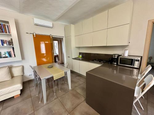 a kitchen with a table and a counter top at Family Relais La Magnolia in Villanova dʼAsti