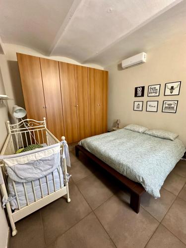 a bedroom with a bed and a wooden cabinet at Family Relais La Magnolia in Villanova dʼAsti