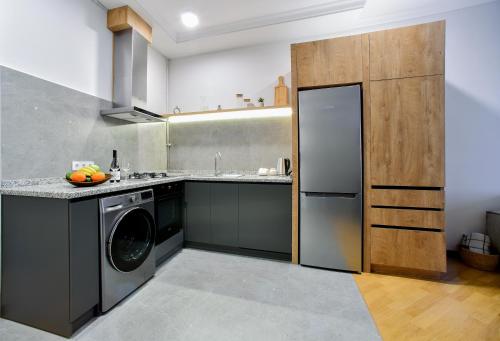 Kuchyň nebo kuchyňský kout v ubytování CheckInn Apartments