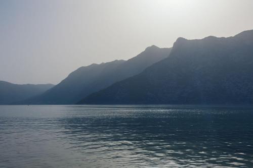 a large body of water with mountains in the background at Stone sea apartment in Risan
