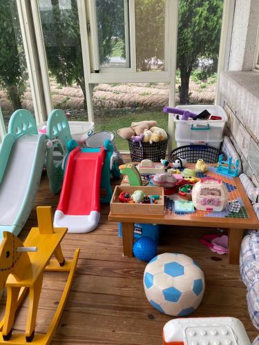 a childs play area with toys and a table at Star House in Tianfu