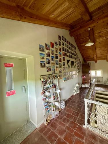 a room with a wall with many pictures on the wall at Family Relais La Magnolia in Villanova dʼAsti