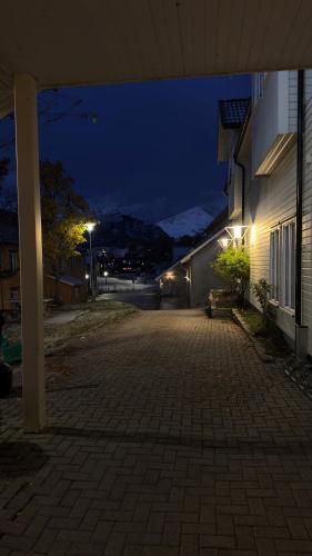 an empty street at night with a building at Hotell Maritim Skjervoy in Skjervøy