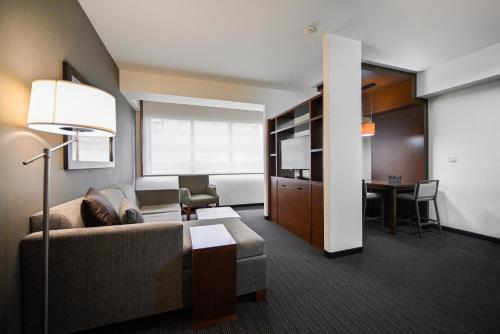 a living room with a couch and a table at Yerevan Place Hotel in Yerevan