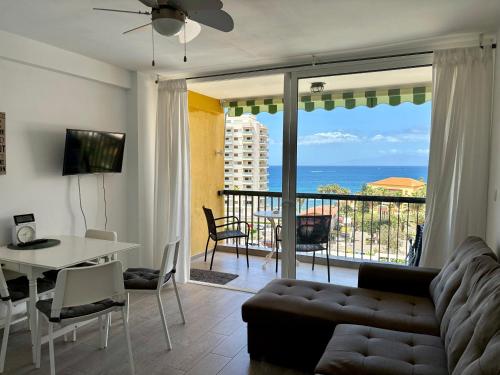 a living room with a couch and a view of the ocean at Sunset Copacabana in Playa Fañabe