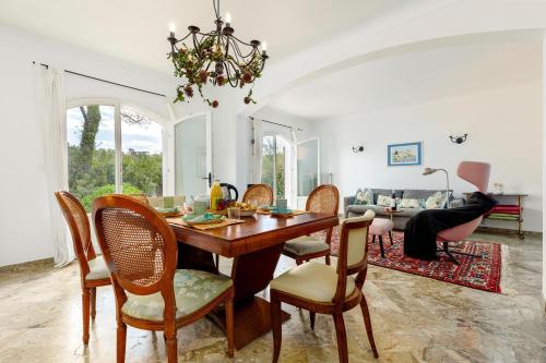 une salle à manger avec une table et des chaises dans l'établissement Provenzalische Villa Berta - mit Terrasse und Garten in Stadtnähe by Riviera HomeLife, à Saint-Raphaël