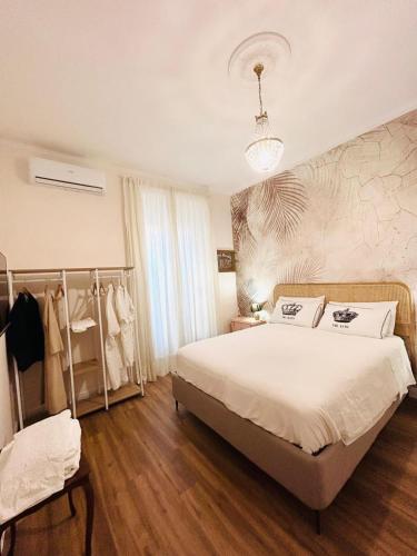 a bedroom with a large white bed and a window at SPAZIO apARTment di stile METROC 8 stops to COLOSSEO in Rome