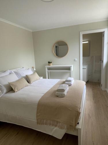 a bedroom with a white bed with towels on it at Brooklyn&Fennel House in Funchal