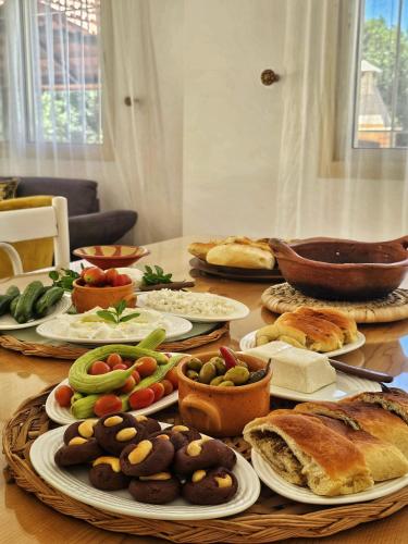 a table with many plates of food on it at Beit Mema in Aḑ Ḑahr