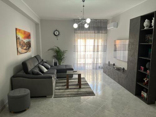 a living room with a couch and a table at Holiday house ice honey in Calatabiano