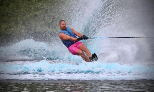a man is water skiing in the water at Willow's Lakeside Lodge With Hot Tub & Hi-Speed Wifi in Stamford