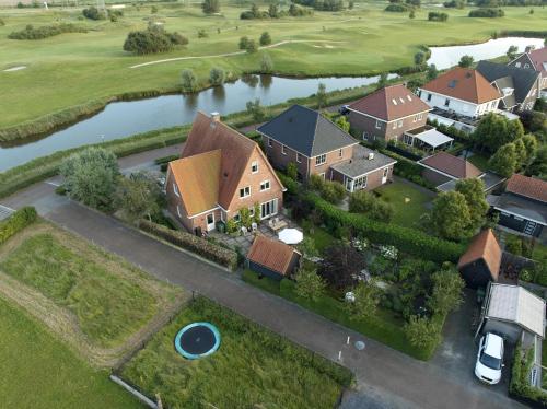 an aerial view of a house with a river at Het Pauzeerhuis in Middelburg