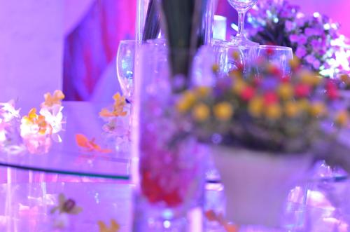 a table with vases and flowers on top at Sai Gon Kim Lien Hotel Vinh City in Vinh