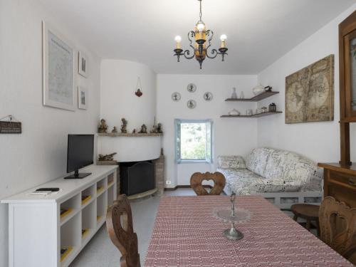 a living room with a table and a couch at Holiday Home Il Castagneto by Interhome in Taggia