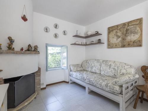 a living room with a couch and a tv at Holiday Home Il Castagneto by Interhome in Taggia