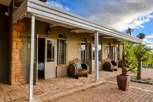a house with awnings on a patio at Blue Rain Guest House in Bloemfontein