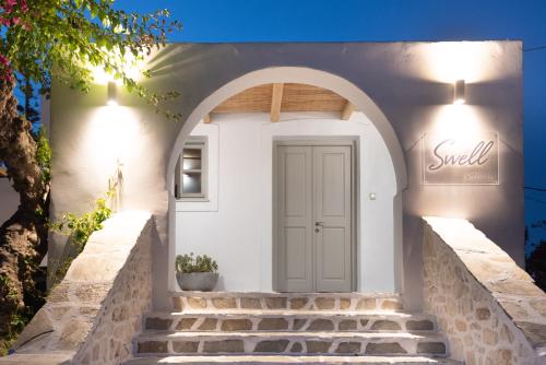 a white house with stairs leading to a door at SWELL S5 new studio in Naousa in Naousa