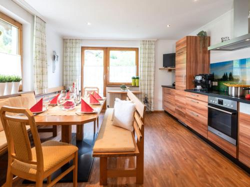 a kitchen and dining room with a table and chairs at Apartment Hirsch by Interhome in See