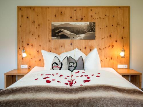 a bedroom with a bed with roses on it at Apartment Hirsch by Interhome in See