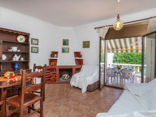 a living room with a fireplace and a table at Holiday Home Omega by Interhome in L'Ametlla de Mar