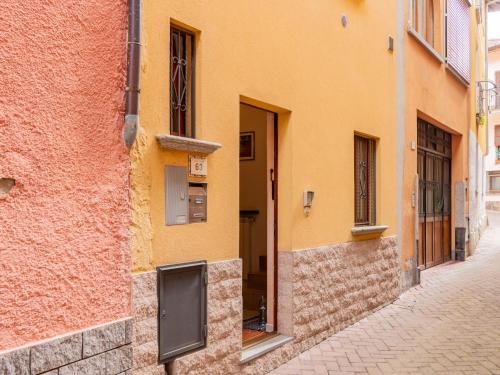a yellow building with a door on a street at Holiday Home Girasole by Interhome in Corrido