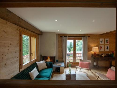 a living room with a couch and a table at Chalet Chalet Shambala by Interhome in Chesières