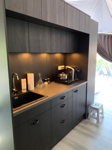 a kitchen with a sink and a counter top at Mill Lake Retreat Hubbards in Hubbards