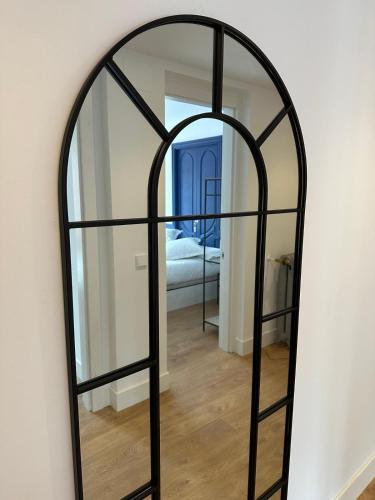 a large mirror with a black frame on a wall at Loben Casona del Deva in Panes