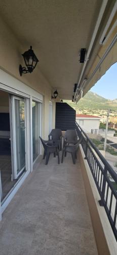 a patio with a table and chairs on a balcony at Deluxe Apartmani Vila Pejovic Sutomore in Sutomore