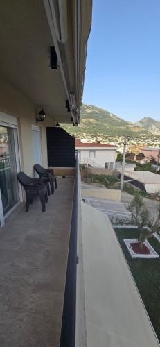 a row of benches sitting on a balcony at Deluxe Apartmani Vila Pejovic Sutomore in Sutomore