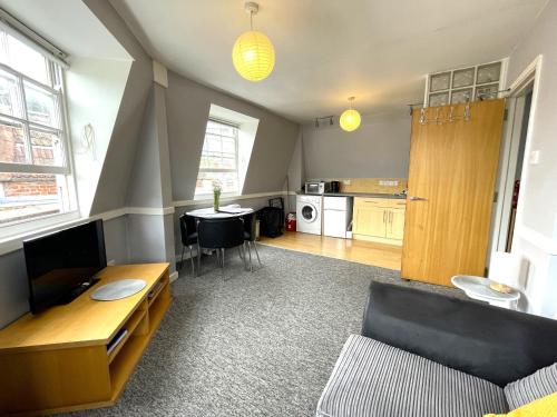 a living room with a couch and a table at Super Central Apartment in Heart of the City in Bristol