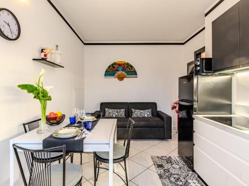 a kitchen and living room with a table and a couch at Apartment Nonna Grazia by Interhome in Lenno