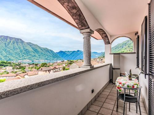 a balcony with a table and a view of mountains at Apartment Nonna Grazia by Interhome in Lenno