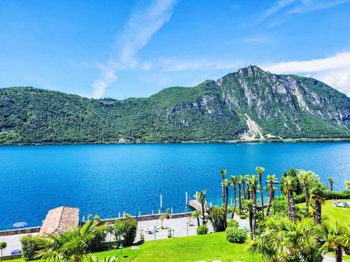 a view of a lake with a mountain in the background at Apartment Lago di Lugano Relax Apt-604 by Interhome in Bissone