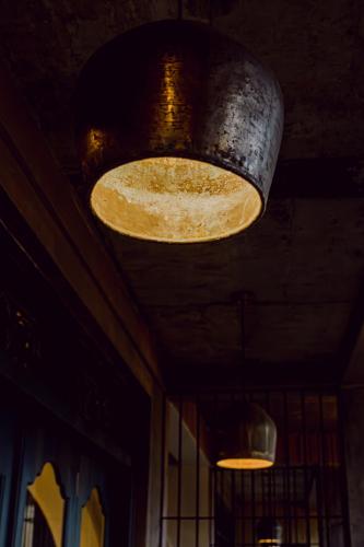 a large light hanging from the ceiling of a restaurant at Still Waters Artistry in Negombo