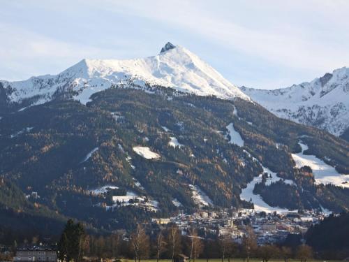 a snow covered mountain with a town in front of it at Holiday Home Rübezahl-3 by Interhome in Bad Hofgastein