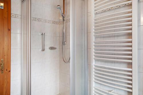 a bathroom with a shower with a glass door at Ferienwohnung Alpspitze in Grainau