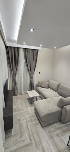 a living room with a couch and a table at Deluxe Apartmani Vila Pejovic Sutomore in Sutomore