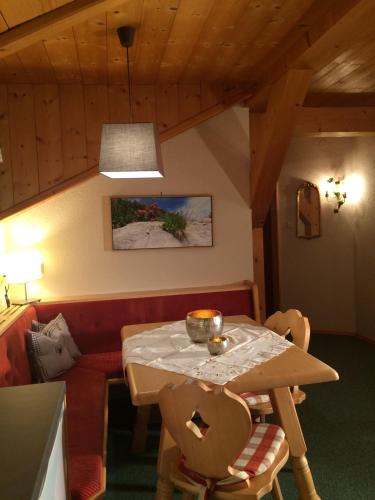 a dining room with a table and a couch at Gasslihof in Sankt Anton am Arlberg