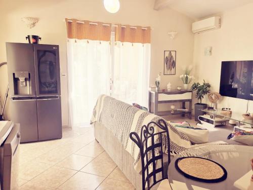 a living room with a couch and a refrigerator at Maison de Charme en couleurs in Cuers