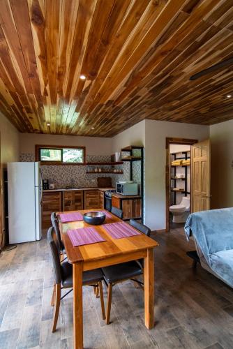 a kitchen and dining room with a wooden ceiling at Corcovado Private Houses-Villas-Tents-Nature-Relaxing in Puerto Jiménez