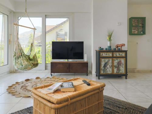 a living room with a couch and a tv at Villa Route de la Muraz 9 by Interhome in Villeneuve