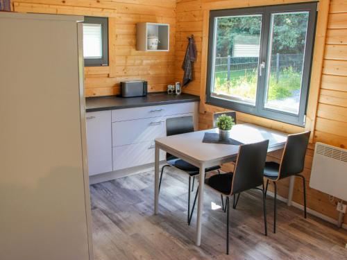 a kitchen and dining room with a table and chairs at Holiday Home Ferienhaus Sarahlita by Interhome in Enspel