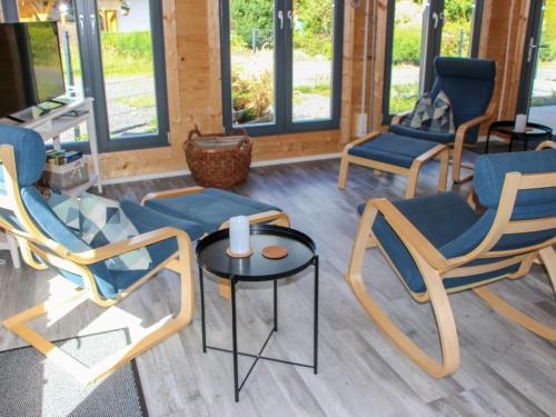 a group of chairs and a table in a room at Holiday Home Ferienhaus Sarahlita by Interhome in Enspel