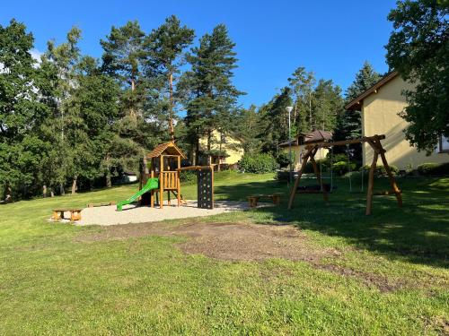 a park with a playground with a slide at Resort-Restaurant Stilec in Kamenný Újezd